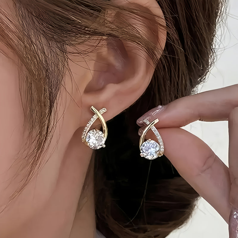 O&O - Golden Cross Zirconia Stud Earrings" can be rewritten as "O&O - Zirconia Stud Earrings with Golden Cross Design.
